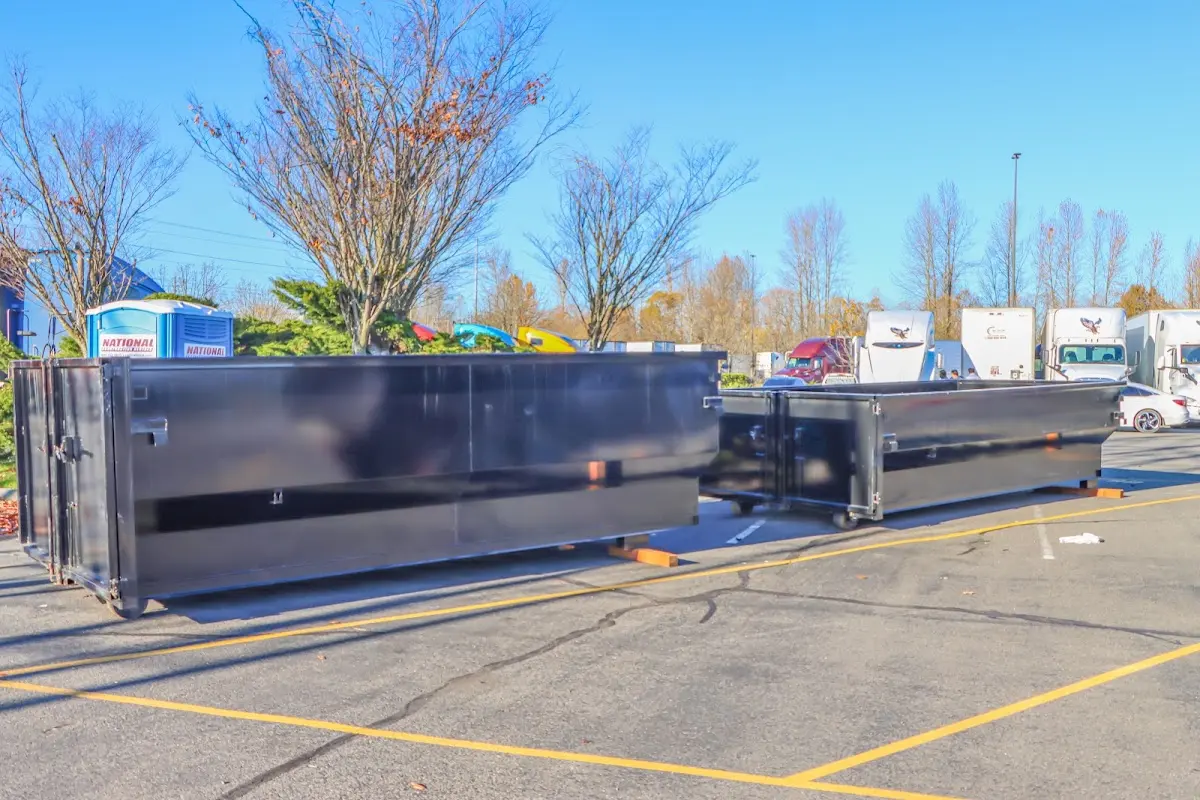 Professional dumpster rental service with roll-off container on residential driveway in Port Orchard